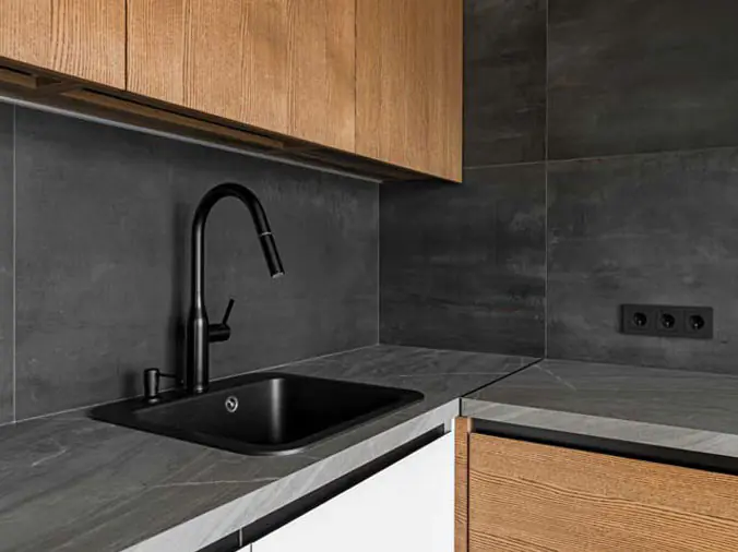 Dark kitchen with black kitchen sink faucxet
