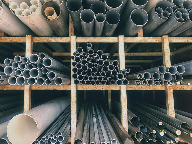 PVC and steel plumbing pipes in a plumbing supply warehouse